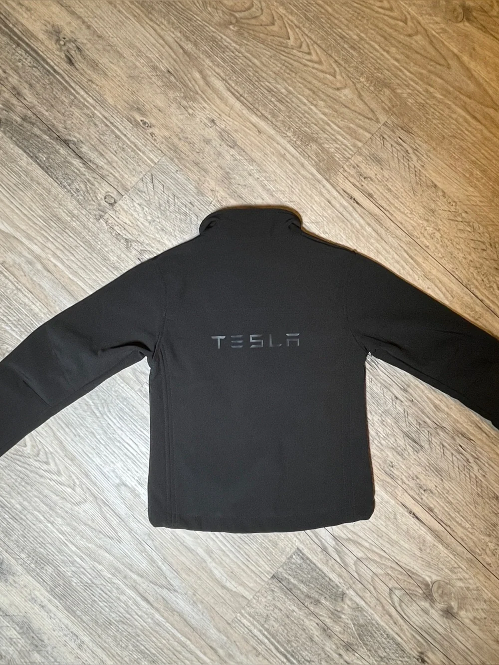 TESLA -The image features a Tesla Kids Corporate Softshell Jacket, black